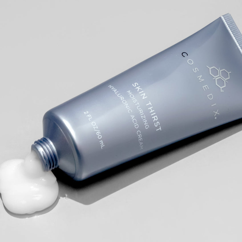 Cosmedix Skin Thirst moisturizing cream tube on a gray background